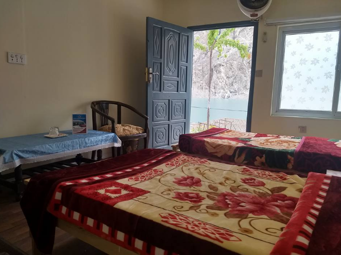 Attabad Lake Hotel room with beds and view of the lake - Rozefstourism.com