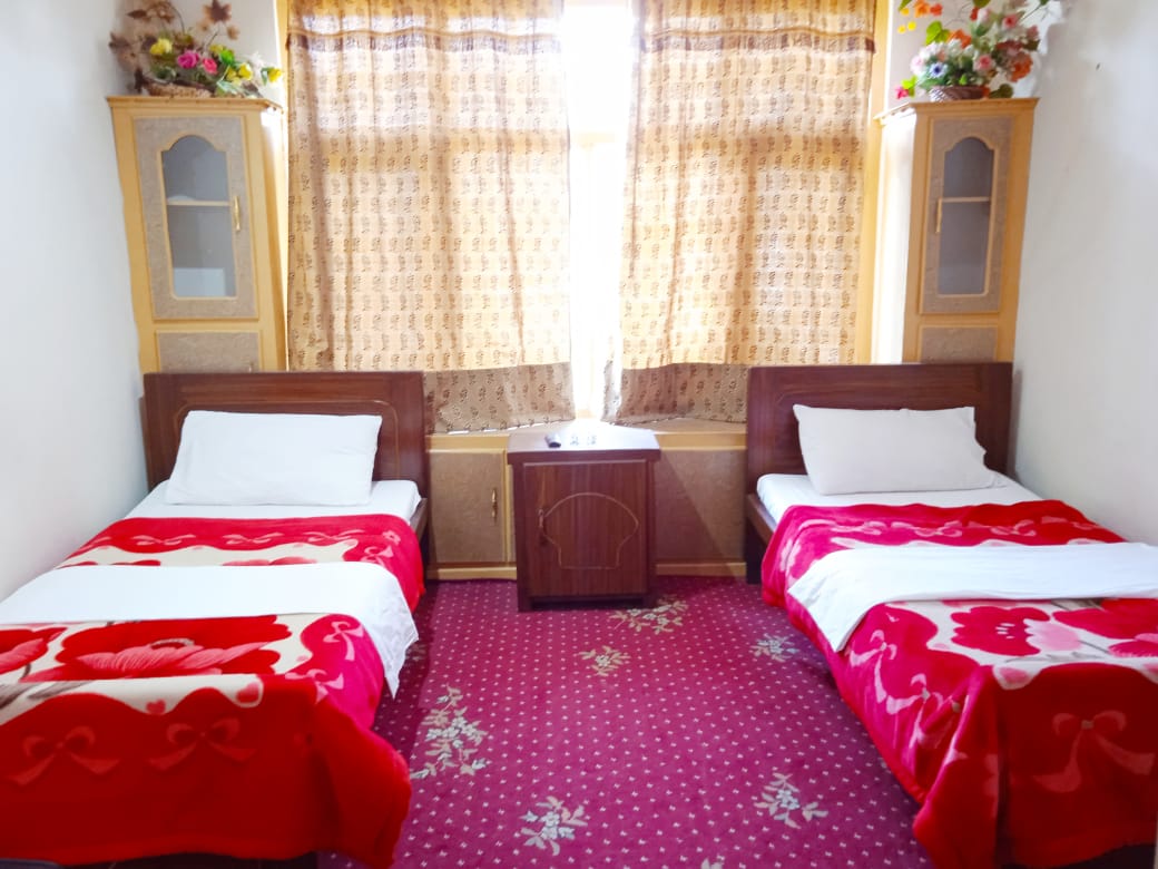 Hotel in Skardu with a window in a room with two beds