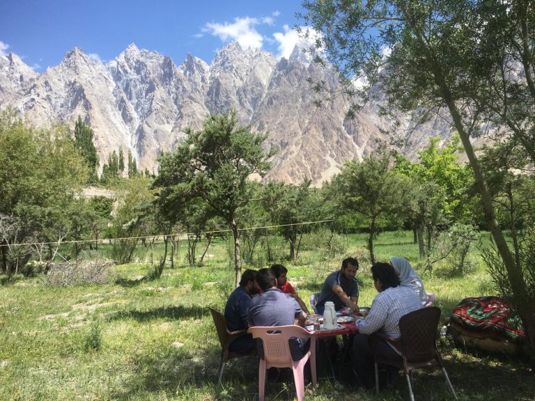 garden of hotel and guest house in passu with passu cones in the background