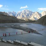 Hussaini Bridge Hunza Valley with Passu Cones in Background - Rozefs Tourism